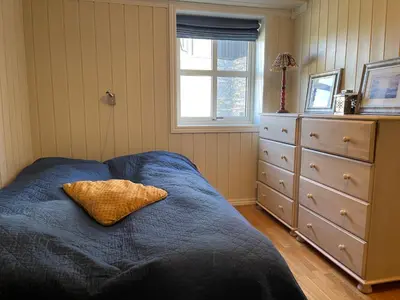 a bedroom with a bed with a pillow and a dresser at Family-Friendly Retreat With Fireplace And Balcony in Beitostøl