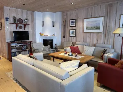 a living room with a couch and a table at Family-Friendly 2-Bedroom With Terrace And Sauna in Beitostøl