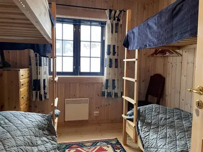 a bedroom with two bunk beds and a window at Family-Friendly 2-Bedroom With Terrace And Sauna in Beitostøl