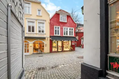 a cobblestone street with red and yellow buildings at Marken Townhouse NEW 2025 in Bergen