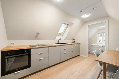 a kitchen with a sink and a stove at Marken Townhouse NEW 2025 in Bergen