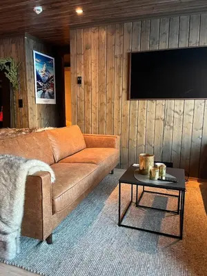 a living room with a couch and a table at UNIQUE, Central Apartment at Geilo in Hol
