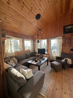 a living room with a couch and a table at Cabin at Furutangen - 3 bedroom family cabin in Åmot