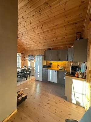 a kitchen with wooden ceilings and a dining room at Cabin at Furutangen - 3 bedroom family cabin in Åmot