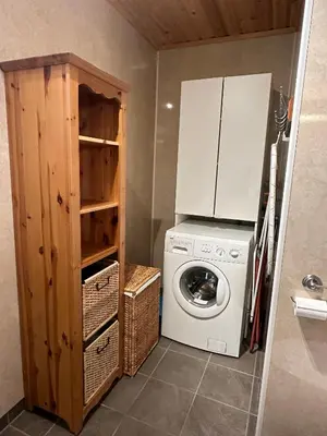 a small kitchen with a washing machine and a cabinet at Cabin at Furutangen - 3 bedroom family cabin in Åmot
