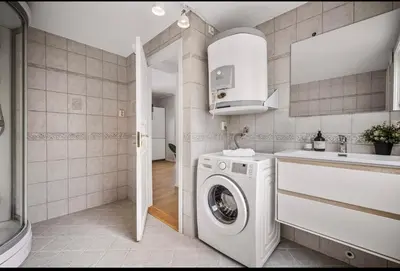 a kitchen with a washing machine and a sink at Central 2 story modern apartment in Bergen