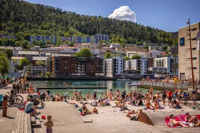 a group of people on a beach near a body of water at Central 2 story modern apartment in Bergen