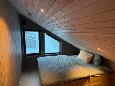 a bed in a room with a wooden ceiling at Kvitfjell Year-round destination-Ski in ski out - World Cup side in Strande