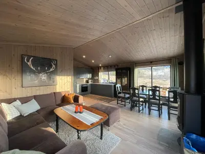 a living room with a couch and a table at Hjertebo by Norgesbooking - cabin at Spåtind in Nord Torpa
