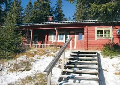 a red cabin with a ramp leading up to it at Trysilfjellet Nord 509 in Trysil
