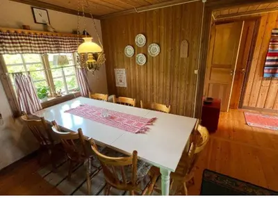 a dining room with a white table and chairs at Trysilfjellet Nord 509 in Trysil
