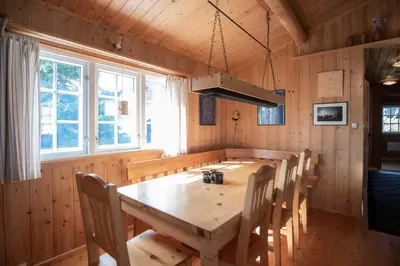 a dining room with a wooden table and chairs at Trysilfjellet Nord 637 in Trysil