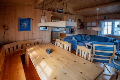 a living room with a table and a blue couch at Trysilfjellet Nord 637 in Trysil
