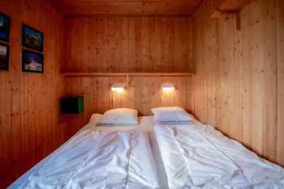 a bedroom with two beds in a wooden room at Trysilfjellet Nord 637 in Trysil