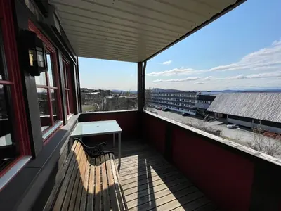 a balcony with a bench and a table on a building at Comfort, Sauna & Great Location! in Beitostøl