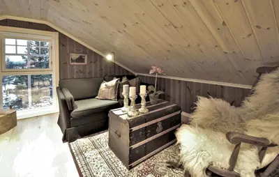 a living room with a couch and a chair at Amazing Home In Gålå With Sauna in Gålå