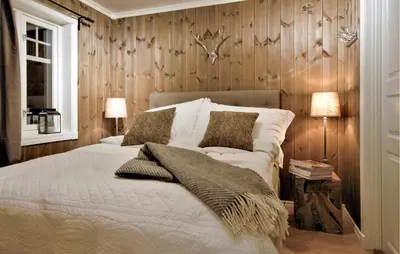 a bedroom with a white bed with wooden walls at Amazing Home In Gålå With Sauna in Gålå