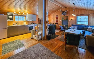 a living room with a blue couch and a kitchen at Amazing Home In Rauland in Rauland