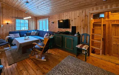 a living room with a blue couch and a table at Amazing Home In Rauland in Rauland