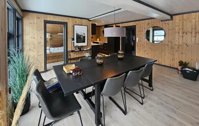 a dining room with a black table and chairs at 3 Bedroom Awesome Apartment In Rjukan in Rjukan