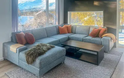 a living room with a blue couch and a table at Awesome Home In Oppdal With Sauna in Oppdal