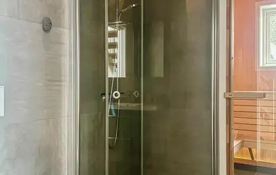 a shower with a glass door in a bathroom at Awesome Home In Oppdal With Sauna in Oppdal
