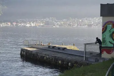 a man standing on a dock in the water at Historic Bergen house, right in the middle of everything! in Bergen