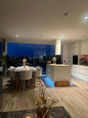 a kitchen and dining room with a table and chairs at Moderne hjem med høy standard og privat takterasse in Trondheim