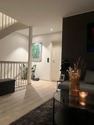 a living room with a couch and a table at Moderne hjem med høy standard og privat takterasse in Trondheim