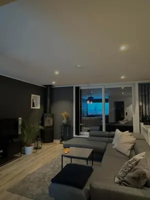 a living room with a couch and a tv at Moderne hjem med høy standard og privat takterasse in Trondheim