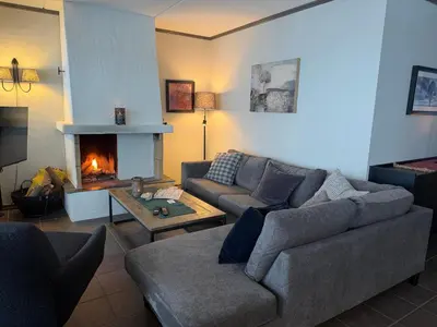 a living room with a couch and a fireplace at Spacious Retreat With Sauna And Parking in Beitostøl