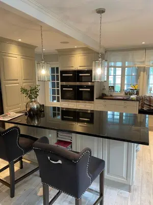 a kitchen with a large black counter and chairs at Exclusive villa in Trondheim in Trondheim
