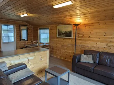 a living room with wooden walls and a couch at Hardangerfjord panorama 1 in Kvam