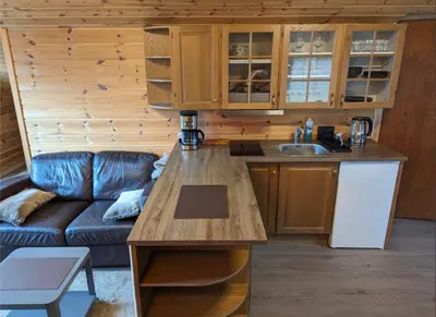 a kitchen with a couch and a table in a room at Hardangerfjord panorama 1 in Kvam