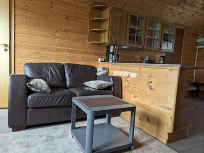 a living room with a couch and a table at Hardangerfjord panorama 1 in Kvam