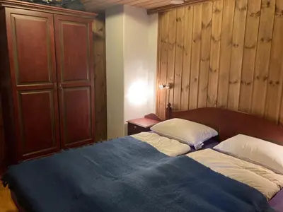 a bedroom with a bed and a cupboard and a bed sidx sidx at Spacious Apartment For Up To 5 Guests in Beitostøl