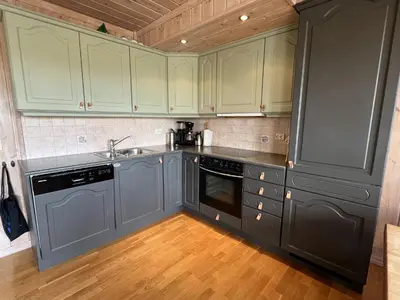 a kitchen with gray cabinets and a sink at Spacious Apartment For Up To 5 Guests in Beitostøl
