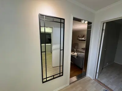 a mirror on a wall in a room at Apartment with a beautiful view in the center of Ålesund in Ålesund