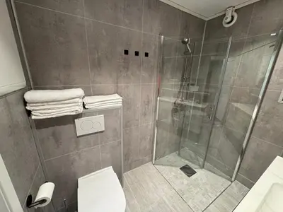 a bathroom with a shower and a toilet at Apartment with a beautiful view in the center of Ålesund in Ålesund