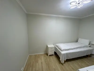 a bedroom with a bed and a light on the ceiling at Apartment with a beautiful view in the center of Ålesund in Ålesund