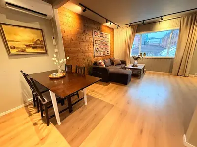 a living room with a table and a couch at Historic Charm in Bergens Heart in Bergen