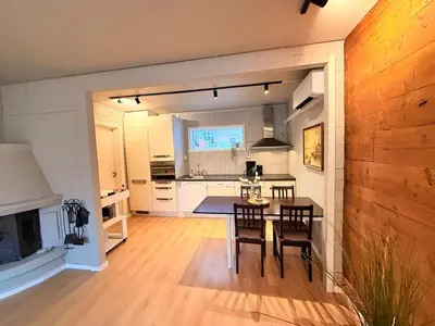 a kitchen and living room with a table and chairs at Historic Charm in Bergens Heart in Bergen