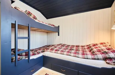 a bedroom with two bunk beds in a house at Newly renovated, centrally located family cabin with mountain view in Beitostøl
