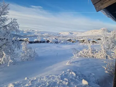 a snow covered village with snow covered trees and houses at Newly renovated, centrally located family cabin with mountain view in Beitostøl