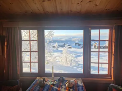 a window with a view of a snow covered yard at Newly renovated, centrally located family cabin with mountain view in Beitostøl