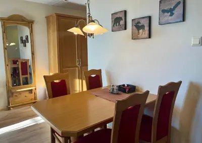 a dining room with a wooden table and chairs at Leilighet midt i sentrum in Beitostøl