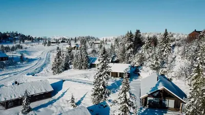 an aerial view of a snow covered village with trees at Modern Mountain Cabin - Sauna - 5 Bedrooms - Sleeps for 10 in Torpo