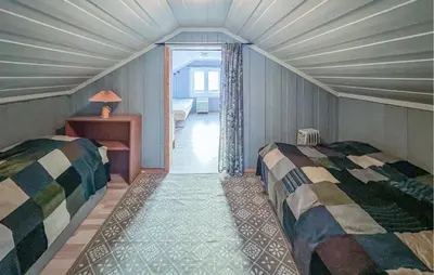 a bedroom with two beds in a room with a window at Gorgeous Home In Svingvoll in Svingvoll