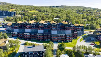 an aerial view of a resort with mountains in the background at Bright, Homey Apartment In Beitostølen Center in Beitostøl