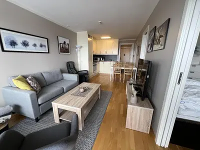 a living room with a couch and a table at Bright, Homey Apartment In Beitostølen Center in Beitostøl